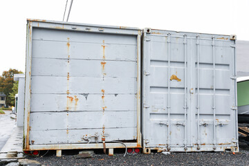 shipping containers stand tall at a bustling port, showcasing global trade, connectivity, and industrial vitality under a clear sky