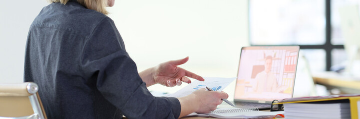 Woman discusses statistic data with colleague on video call