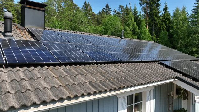 Drone shot around sunlight absorbers on the roof a solar powered, renewable house
