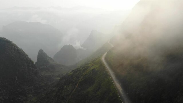 Low clouds on Ma pi leng pass Vietnam with motorbike driving, aerial