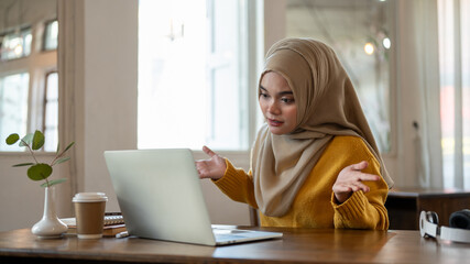 Strict Asian-Muslim businesswoman is complaining about her employee online through an online meeting
