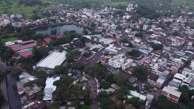 Drone shot of crowd of Hindu devotees walking towards Trimbakeshwar Temple dedicated to Lord Shiva at the foothills of the Brahmagiri and Gangadwar mountains, Trimbak Town, Nashik, Maharashtra, India