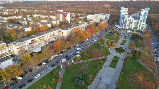 Panoramic aerial drone view of Afghan War Memorial To Sons of Motherland - Eternal Memory at autumn season. Multiple residential buildings, cars riding on background. Chisinau, Moldova. 4K video.