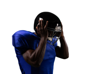 Digital png photo of african american male rugby player holding helmet on transparent background