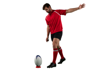 Digital png photo of caucasian male rugby player kicking ball on transparent background