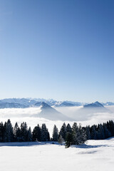 Scenic view of the swiss alps above the fog in winter