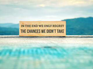 Inspirational motivational quote concept background - In the end we only regret the chances we didn't
take.