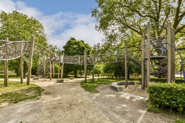 an outdoor play area with swings, slides and slides in the middle part of the park on a sunny day