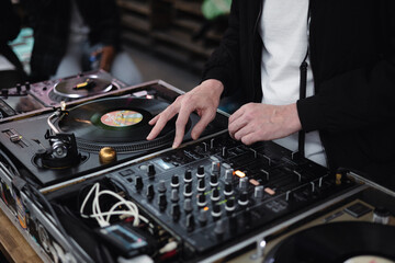 dj working at the club, sharing music with classic disc and turntable