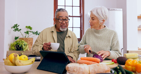 Senior couple, cooking and tablet in kitchen with knife, vegetables and tea cup for conversation. Interracial marriage, elderly woman and old man with touchscreen for app, food or nutrition in home