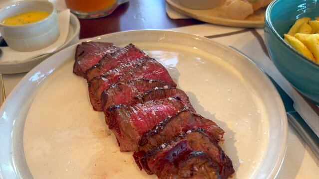 Tasty beef filet steak with french fries at Bibo Beach House Tarifa restaurant, tapas of Dani Garcia in Spain, 4K shot