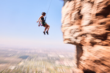 Sports, rock climbing and jump with woman on mountain for fitness, adventure and challenge....