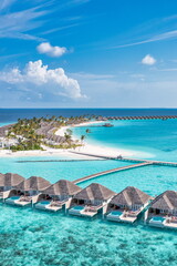 Picturesque aerial landscape luxury tropical island resort with water villas. Beautiful island beach palm trees, sunny sea sky. Amazing bird eyes view in Maldives paradise coast. Exotic best vacations