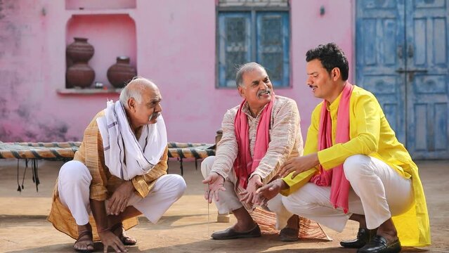 Three indian villagers discussing at out of home.