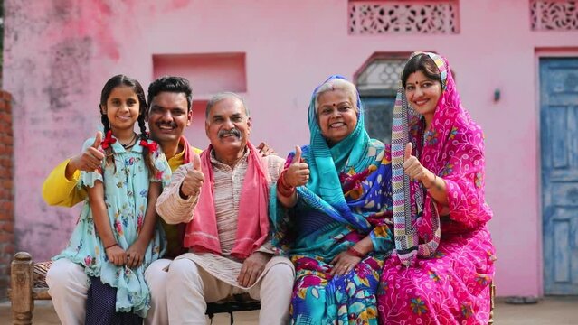 indian farmer family showing thumps up