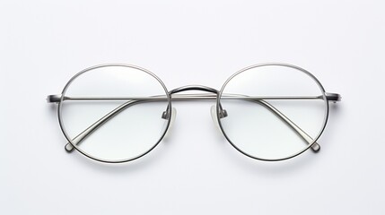 A pair of sophisticated reading glasses, their sleek metal frame reflecting light, placed horizontally on a pristine white backdrop.