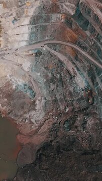 Dramatic aerial over a vast open pit gold and silver mine. A common site in the Philippines