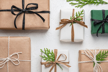 Craft gift boxes on a white background, conifer branches. Concept for Christmas holidays and DIY...