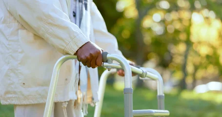 Foto op Canvas Hands, walking frame and a senior person in a garden outdoor in summer closeup during retirement. Wellness, rehabilitation or recovery and an elderly adult with a disability in the park for peace © Charlize D/peopleimages.com