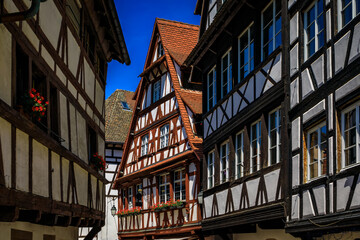 Ornate traditional half timbered houses with blooming flowers along the canals in the picturesque Petite France district of Strasbourg, Alsace, France