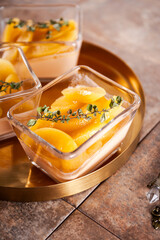 Traditional Italian dessert panna cotta with peaches, vertical photo