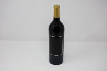 A black sealed wine bottle with blank label and copy space. 