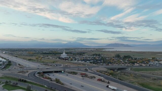 Orem and Provo, Utah along Interstate 15 at sunrise - pullback aerial reveal