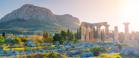 Ruins of temple of Apollo at sunset, Ancient Corinth in Greece