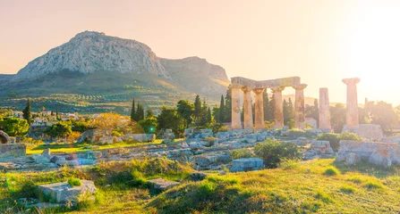 Fotobehang Ruins of temple of Apollo at sunset, Ancient Corinth in Greece © M.studio