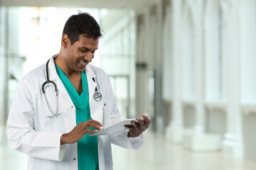 Doctor using a touch-pad PC in a medical clinic.