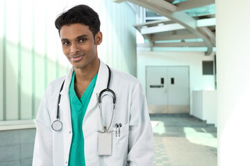 Indian Doctor standing outside a hospital.