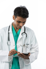 Young Indian surgeon holding a touch-pad PC.