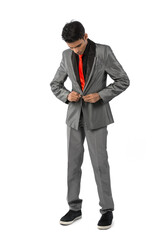 Indian man buttoning up his suit.