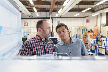 two men in production office