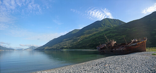 Shipwreck site in small bay, Old rusty whaling ship on the sea shore, Kamchatka, Morzhovaya bay - obrazy, fototapety, plakaty