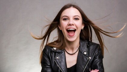 Portrait of a beautiful rocker woman in a black leather jacket on a studio background. Screaming girl isolted exemplifies youthful rebellion, alternative fashion, self-expression - obrazy, fototapety, plakaty
