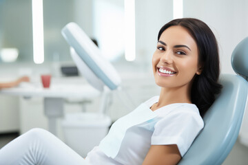 A woman sitting in the dentist office, smiling - obrazy, fototapety, plakaty