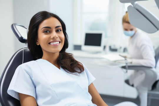 A woman sitting in the dentist office, smiling