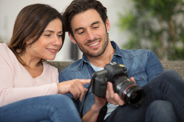man and woman looking back over photos on their camera