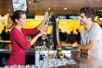 pretty waitress standing at the counter talking to a customer