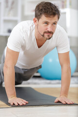 man in plank position exercising at home