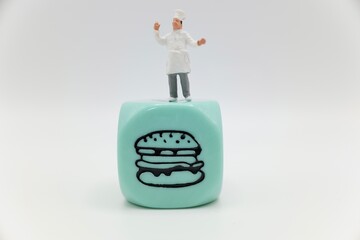 miniature figurine of a chef with a symbol of fast food 
