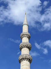 minaret of a mosque over beautiful blue sky
