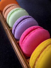 row of colorful macaroons in a box