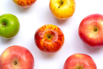 Variety of fresh apples on white background.