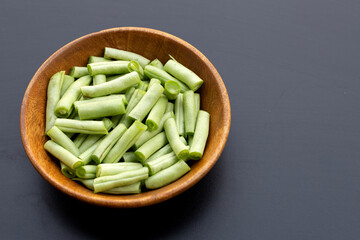 Green beans on dark background.