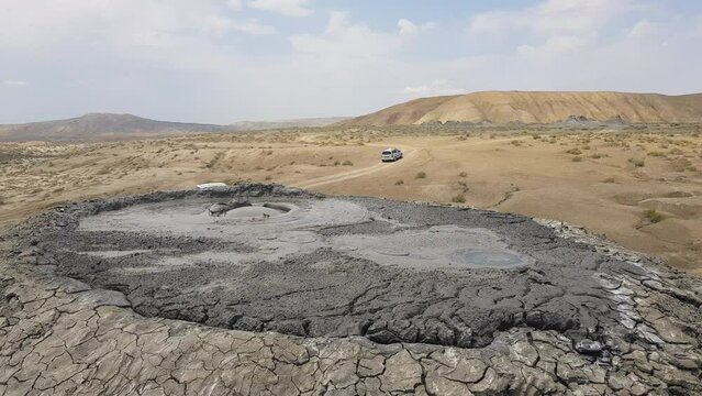 Vehicles Passing by Under Mud Volcano in Gobustan National Park, Azerbaijan
