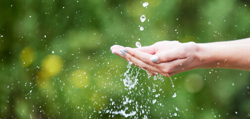 Woman, hands and palm with water for natural sustainability, washing or cleanse in nature. Closeup...
