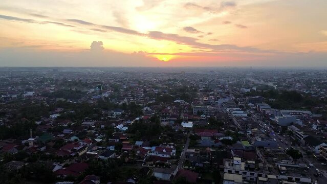 Aerial 4k video of Pekanbaru city during sunset. The capital city of Riau province with many residential buildings.