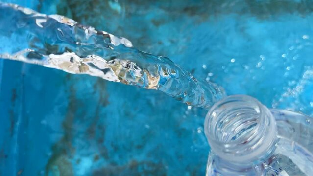 drinkable from natural drinking water, filling it into a bottle from a healthy fountain and drinking it